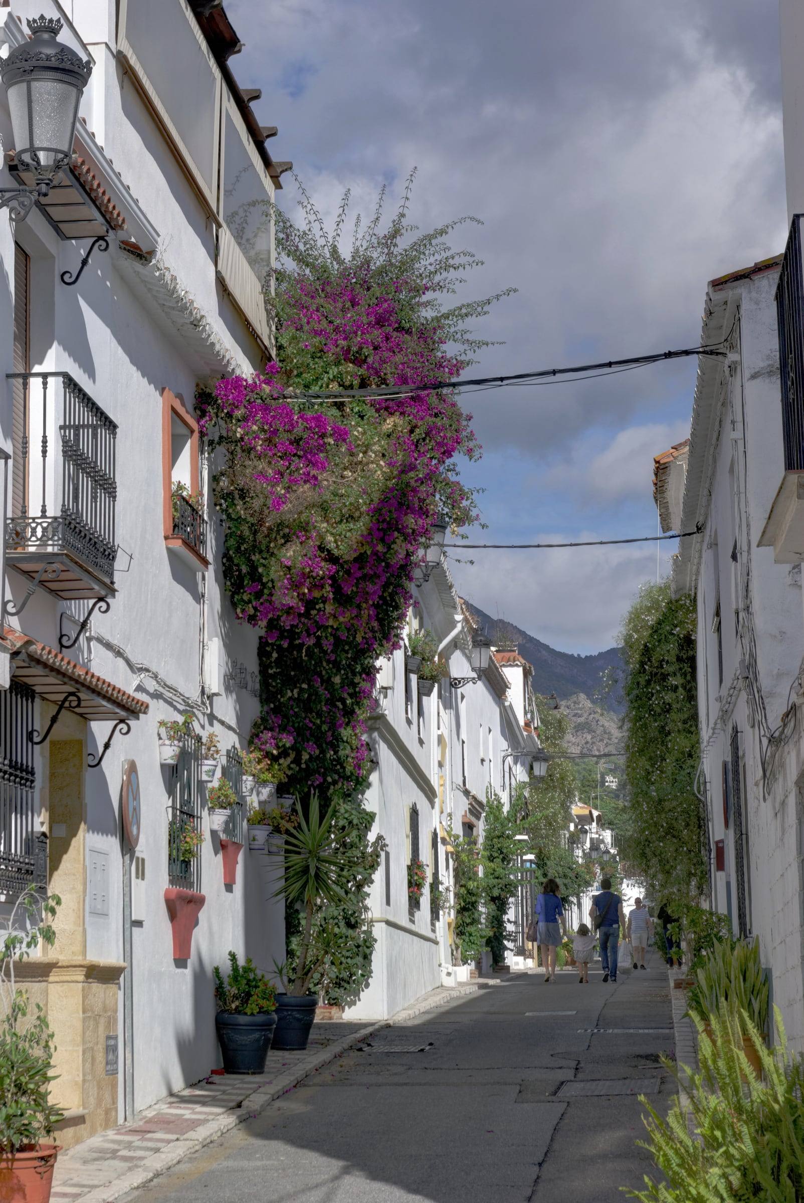 A whitewashed street in Marbella’s old town, with bougainvillea climbing a house front