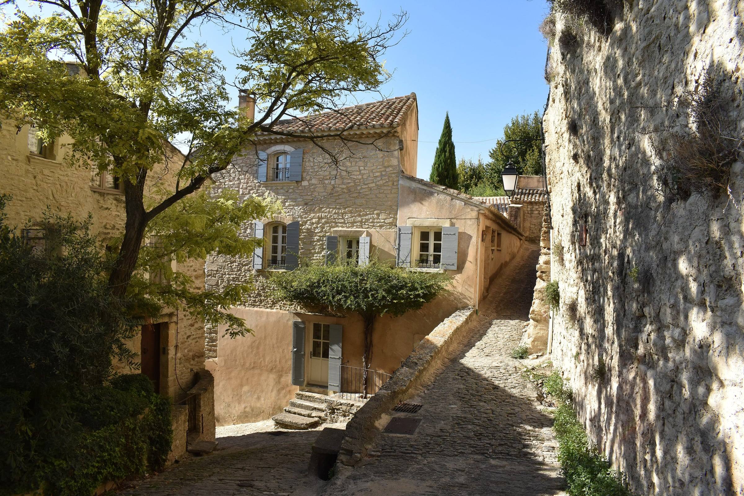 A quiet stone lane with shuttered houses in Gordes, Provence